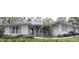 Charming single-story home with a welcoming entrance, lush landscaping, and neutral exterior paint at 2930 Westgate Dr, Eustis, FL 32726