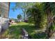 View of the lush backyard with stepping stone path, storage shed and mature landscaping at 3006 Northwood Blvd, Winter Park, FL 32789