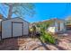 Exterior view of backyard featuring a storage shed, lush landscaping, and brick paver patio at 3006 Northwood Blvd, Winter Park, FL 32789