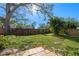 Backyard view featuring a wood fence, grass lawn, mature trees and tropical landscaping at 3006 Northwood Blvd, Winter Park, FL 32789