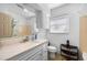 Bathroom featuring large vanity, neutral tile, and well-lit mirror at 3006 Northwood Blvd, Winter Park, FL 32789