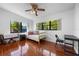 Sunny bedroom with hardwood floors, two large windows, and a ceiling fan at 3006 Northwood Blvd, Winter Park, FL 32789