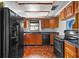 Functional kitchen featuring black appliances, ample cabinet space, and hardwood floors at 3006 Northwood Blvd, Winter Park, FL 32789