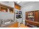 Compact kitchenette features stainless sink, granite countertop, and vintage wooden cabinet at 3006 Northwood Blvd, Winter Park, FL 32789