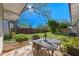 Outdoor patio with dining table and chairs, surrounded by lush landscaping at 3006 Northwood Blvd, Winter Park, FL 32789