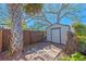 A storage shed with a brick paver path, located in a fenced yard under mature trees at 3006 Northwood Blvd, Winter Park, FL 32789