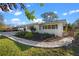 Well manicured yard with healthy plants and flowers, featuring a short retaining wall around the landscaped area at 3006 Northwood Blvd, Winter Park, FL 32789