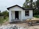 Charming new construction with white exterior and black trim, displaying a modern aesthetic at 3027 Turkey Ave, Oviedo, FL 32765