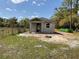 New construction home featuring concrete block exterior and a modest yard under a bright blue sky at 3027 Turkey Ave, Oviedo, FL 32765