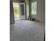 Spacious room with ample natural light streaming through the window, with a door leading outside at 3027 Turkey Ave, Oviedo, FL 32765