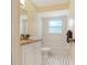 Bathroom featuring a bath tub, white tile flooring and a sleek vanity, offering a refreshing space at 323 Marjorie Blvd, Longwood, FL 32750