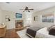 Bedroom featuring hardwood floors, fireplace, ceiling fan and a picturesque window view at 323 Marjorie Blvd, Longwood, FL 32750