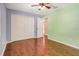 Bedroom with hardwood floors, ceiling fan, closet, and ensuite bathroom at 323 Marjorie Blvd, Longwood, FL 32750