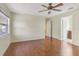 Spacious bedroom with hardwood floors, a ceiling fan, and an ensuite bathroom at 323 Marjorie Blvd, Longwood, FL 32750