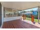 Covered deck with orange stained wood, screen, and stairs leading into a fenced backyard at 323 Marjorie Blvd, Longwood, FL 32750