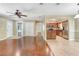 Open-concept living area with hardwood floors, tile accents, and seamless flow to the modern kitchen at 323 Marjorie Blvd, Longwood, FL 32750