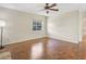 Bright living room with hardwood floors, a ceiling fan, and natural light from the window at 323 Marjorie Blvd, Longwood, FL 32750