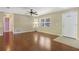 Bright living room with hardwood floors, a ceiling fan, and natural light from the window at 323 Marjorie Blvd, Longwood, FL 32750