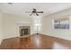 Living room featuring hardwood floors, fireplace, ceiling fan and a picturesque window view at 323 Marjorie Blvd, Longwood, FL 32750