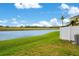 Backyard view with well-maintained lawn and scenic view of community lake at 3466 Allegra Cir, St Cloud, FL 34772