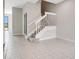 Spacious foyer with tile flooring, staircase, and light gray walls in a home's entryway at 3466 Allegra Cir, St Cloud, FL 34772