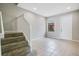 Bright entryway featuring tile flooring, a staircase, and a white front door with sidelight at 3466 Allegra Cir, St Cloud, FL 34772