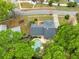 Bird's eye view of the property with a pristine pool, verdant landscaping, and neighborhood context at 3553 Jericho Dr, Casselberry, FL 32707