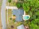 Overhead view of the home featuring a backyard pool, lush landscaping, and the surrounding neighborhood at 3553 Jericho Dr, Casselberry, FL 32707