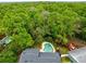 Aerial view showcasing a backyard pool with surrounding mature trees providing shade and privacy at 3553 Jericho Dr, Casselberry, FL 32707