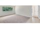 Empty bedroom with a large window providing natural light and neutral carpet at 3553 Jericho Dr, Casselberry, FL 32707