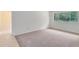 Empty bedroom with a large window providing natural light and neutral carpet at 3553 Jericho Dr, Casselberry, FL 32707