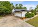 Side view of the home showing a two-car garage and a concrete driveway at 3553 Jericho Dr, Casselberry, FL 32707