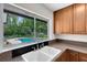 Kitchen sink with view of lush backyard and pool at 3553 Jericho Dr, Casselberry, FL 32707