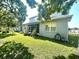 Expansive backyard featuring a well-maintained lawn, screened porch, and lush landscaping at 3810 Blue Dasher Dr, Kissimmee, FL 34744