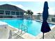 Community pool with clear blue water and lounge seating for relaxation at 3810 Blue Dasher Dr, Kissimmee, FL 34744