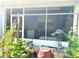 View of the screened porch area featuring plants and an exterior view at 3810 Blue Dasher Dr, Kissimmee, FL 34744