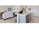 Modern kitchen island featuring a quartz countertop, stainless steel appliances, and seating at 3909 Diving Dove Ln, Bartow, FL 33830