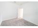 Bright bedroom features neutral carpet and a doorway leading to another room at 4032 Redbridge Loop, Davenport, FL 33837