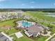 Beautiful aerial view of the community pool, clubhouse, and playground surrounded by well-maintained landscaping at 4086 Gooseberry Trl, Kissimmee, FL 34746