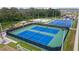 Bright aerial shot of community tennis courts and park featuring a soccer goal and a basketball court at 4086 Gooseberry Trl, Kissimmee, FL 34746