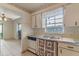 Traditional kitchen with white cabinets, a vintage dishwasher, and tiled floors at 412 N Boyd St, Winter Garden, FL 34787