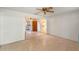 View of the living room showing the ceiling fan and doorway to the kitchen with white cabinetry at 412 N Boyd St, Winter Garden, FL 34787