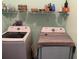 Well organized laundry room with newer model machines and storage shelf at 428 Ohio Ln, Kissimmee, FL 34759