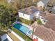 Aerial view of home featuring solar panels, a private pool, and a manicured patio perfect for outdoor relaxation at 4457 Anson Ln, Orlando, FL 32814