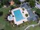 Overhead view of an outdoor pool, lounge chairs, and clubhouse, a relaxing oasis for residents at 4457 Anson Ln, Orlando, FL 32814