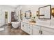 Bright bathroom featuring dual vanities, a soaking tub, and designer light fixtures at 4457 Anson Ln, Orlando, FL 32814