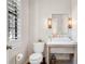 Charming half bathroom with a modern vanity, decorative lighting, and natural light from the shuttered window at 4457 Anson Ln, Orlando, FL 32814