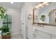 Bathroom vanity with marble countertop, gold hardware, and a rustic-framed mirror with decor at 4457 Anson Ln, Orlando, FL 32814