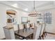 Elegant dining room featuring a large table, upholstered chairs, chandelier, and natural light at 4457 Anson Ln, Orlando, FL 32814