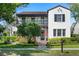 Charming two-story home with a stucco exterior, balcony, dark shutters, and well-manicured landscaping at 4457 Anson Ln, Orlando, FL 32814